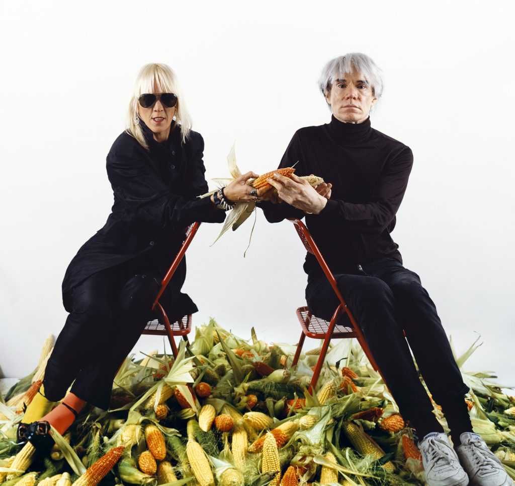 Marta Minujín and Andy Warhol, El pago de la deudaexterna argentina con maíz, “el oro latinoamericano" (Paying Off the Argentine Foreign Debt with Corn, “the Latin American Gold”), the Factory, New York, 1985 / 2011, Chromogenic color print, 36 3/8 × 39 1/4 in. (92.4 x 99.7 cm). Collection of the artist. © Marta Minujín, courtesy of Henrique Faria, New York and Herlitzka & Co., Buenos Aires.